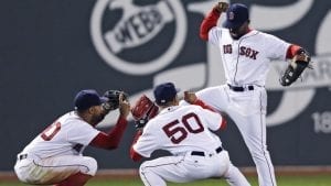 Boston Red Sox center fielder Jackie Bradley Jr., right, celebrates with Chris Young (30) and Mookie Betts (50) after the team's baseball game against the Colorado Rockies in Boston, Tuesday, May 24, 2016. Bradley extended his hitting streak to 28 games as the Red Sox defeated the Rockies 8-3. (AP Photo/Charles Krupa)