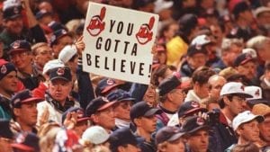 CLEVELAND, OH - OCTOBER 24: A Cleveland Indians fan in the crowd at Cleveland's Jacobs Field holds up a sign reading "Ya Gotta Believe" at the start of game three of the World Series 24 October. The Atlanta Braves have won the first two games of the best-of-seven series. AFP PHOTO (Photo credit should read ROBERT SULLIVAN/AFP/Getty Images)