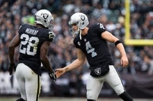Dec 6, 2015; Oakland, CA, USA; Oakland Raiders quarterback Derek Carr (4) high fives running back Latavius Murray (28) after Murray's play was reviewed to be a touchdown against the Kansas City Chiefs during the first quarter at O.co Coliseum. Mandatory Credit: Kelley L Cox-USA TODAY Sports